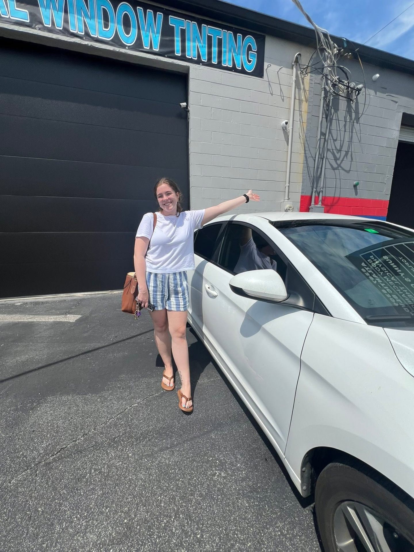 Happy Lifetime Tint customer with her freshly tinted car
